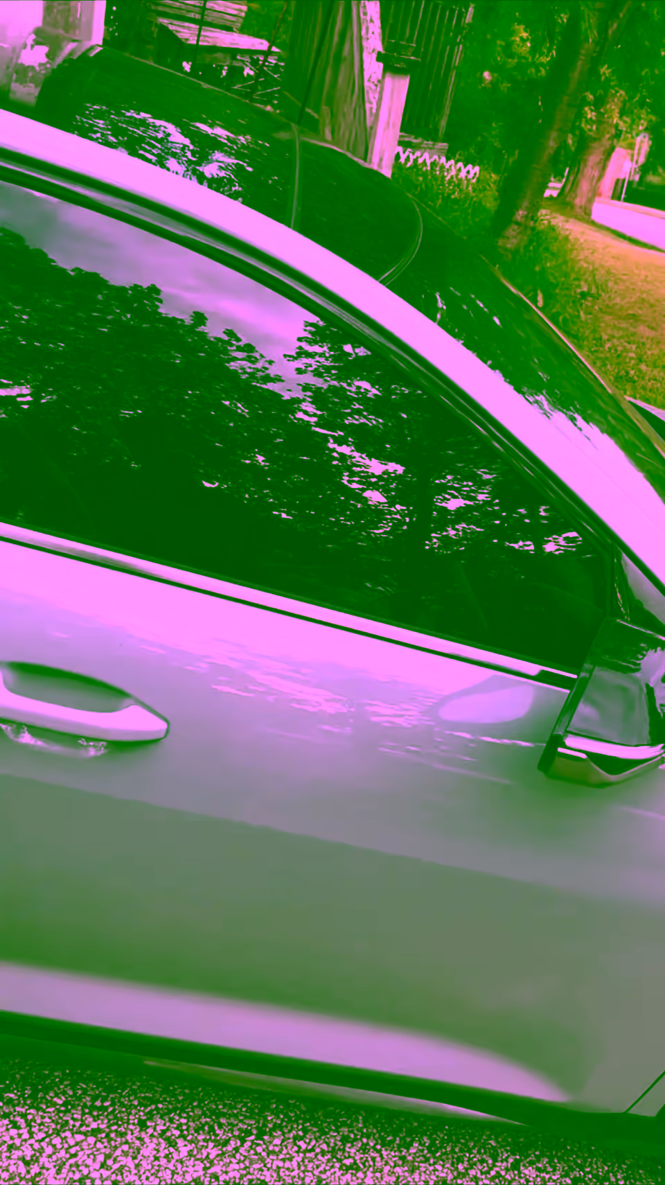 Close view of freshly tinted front door glass on a green SUV